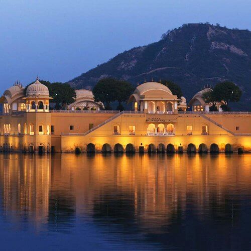 Jal Mahal illuminated at night in Jaipur, featured in BAWA GUEST HOUSE’s Jaipur Discovery Tour package.